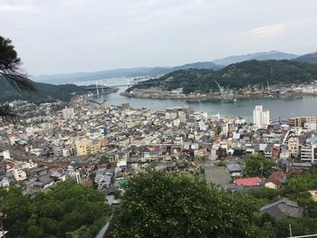 High angle view of townscape and bay against sky