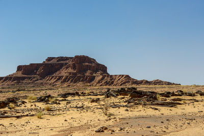 Rock formations in desert against clear sky