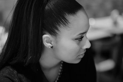 Close-up of woman looking away at home