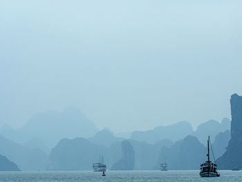 Sailboat in sea against clear sky