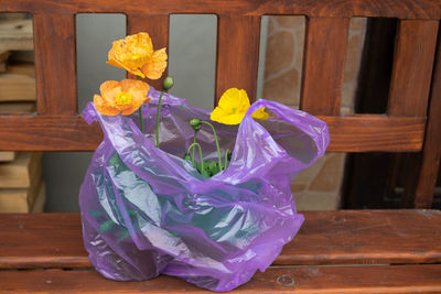 Close-up of yellow flower vase on table