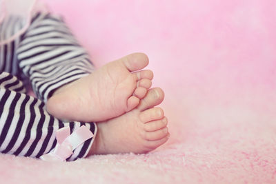 Low section of baby feet