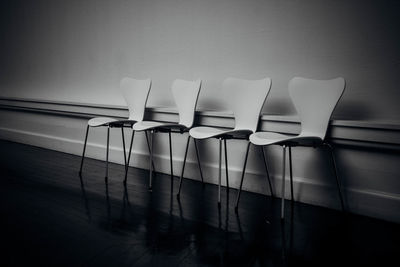 Chairs arranged against wall
