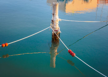 High angle view of fishing net hanging over sea