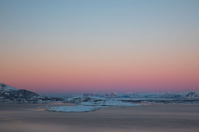 Scenic view of sea against clear sky during sunset