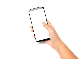 Midsection of person using smart phone against white background