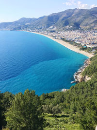 High angle view of sea and mountains against sky