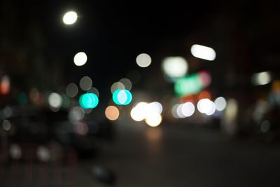 Defocused image of illuminated city street at night