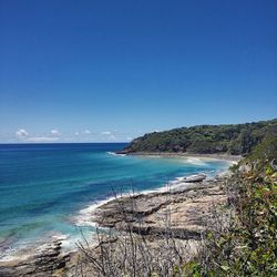 Scenic view of sea against clear blue sky