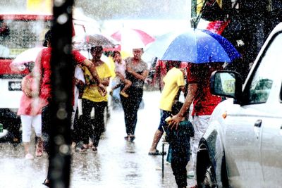 People on wet road in rain