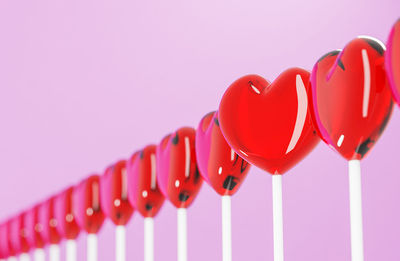 Close-up of red balloons over white background