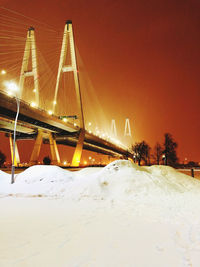 Illuminated suspension bridge during winter at night
