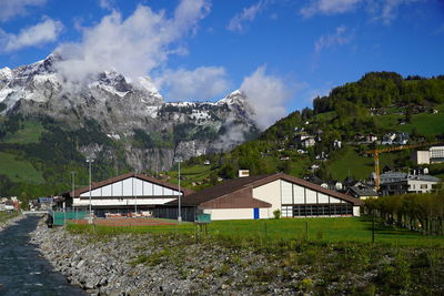 Panoramic view of houses and mountains against sky