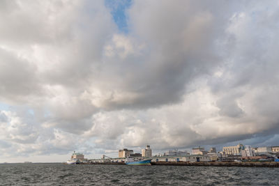 Panoramic view of sea and buildings against sky