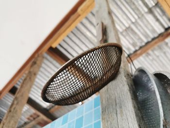 Low angle view of electric fan on roof