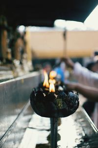 Close-up of diyas burning at temple