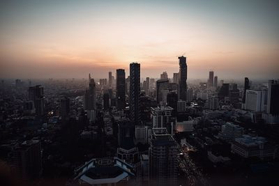 Aerial view of city buildings during sunset