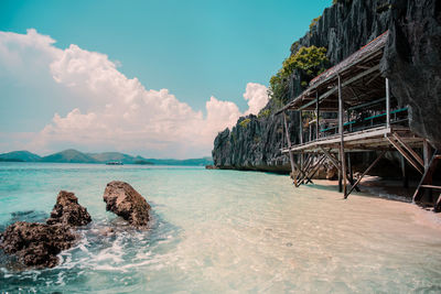 Wooden cottage at the white sand shore at limestone island of coron, palawan, philippines.