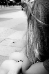 Close-up of girl sitting outdoors