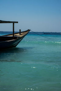 Swimming pool by sea against blue sky