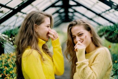 Happy twins in greenhouse