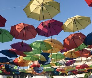 Low angle view of colorful umbrellas against sky