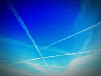 Low angle view of vapor trails in sky