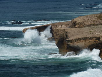 Waves splashing on rocks at sea