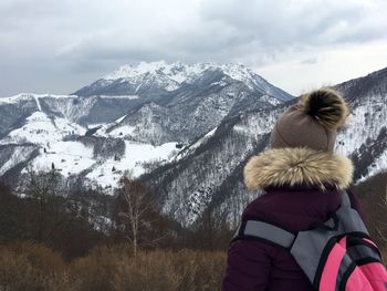 Hiker looking at snowcapped mountains