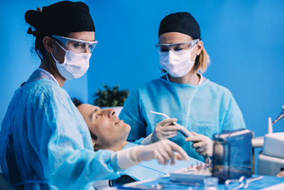 Dentists operating patient in medical clinic