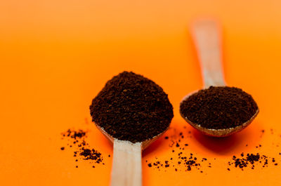 Close-up of cake on table against orange background