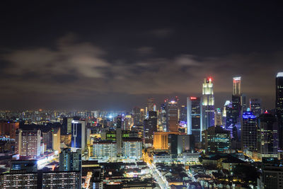 Illuminated cityscape against sky at night