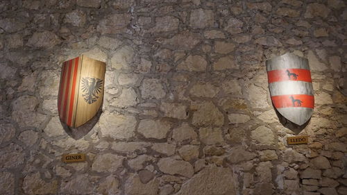 Close-up of electric lamp hanging on wall