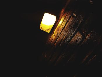 Low angle view of illuminated lamp against sky at night