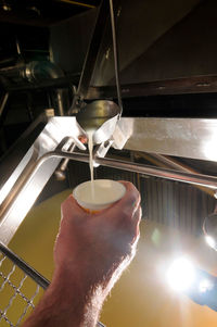 Midsection of man working with coffee cup