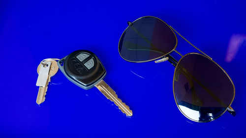 Close-up of sunglasses against blue sky