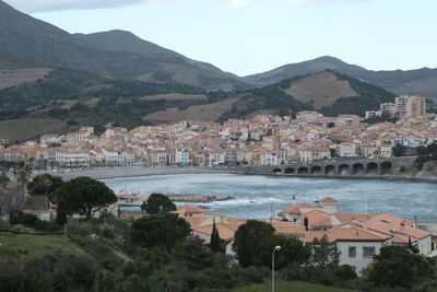 High angle view of townscape and mountains against sky