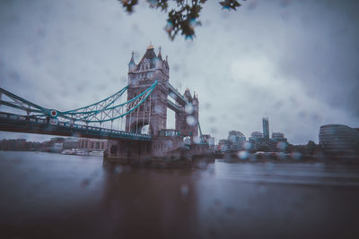 Bridge over river with buildings in background