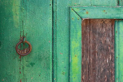 Detail of traditional door knocker in a traditional portuguese wooden door