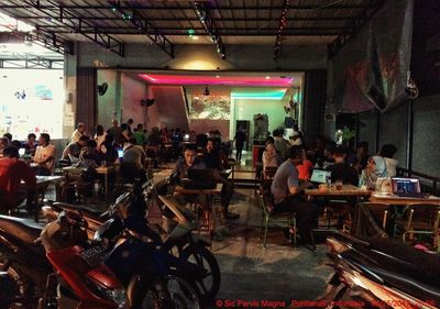 People sitting on table in illuminated room