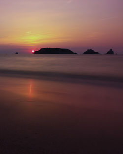 Scenic view of sea against romantic sky at sunset