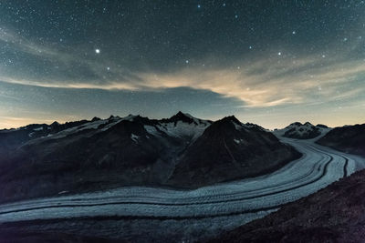 Scenic view of mountains against sky at night