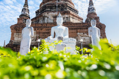 Statue of temple against building