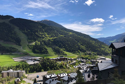 High angle view of townscape and mountains against sky