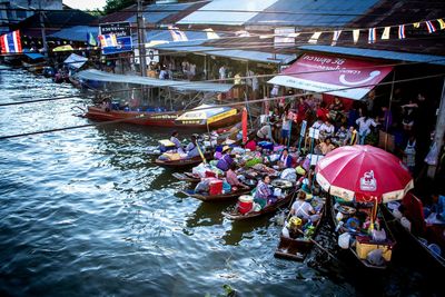 People in boat at market