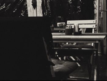 Rear view of woman sitting on bench in restaurant