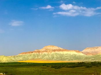 Scenic view of mountain against blue sky