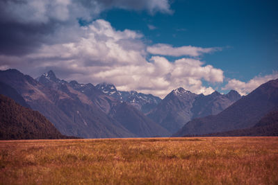 Scenic view of landscape and mountains against sky