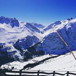 Snow covered mountains against blue sky