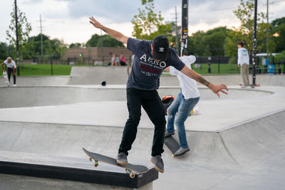 Full length of man skateboarding on skateboard in city